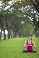 Young woman practicing yoga in park