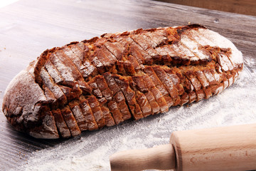 freshly baked bread on wooden board. cutted bread