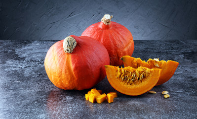 Pumpkin slices with seeds and autumn hokkaido pumpkins
