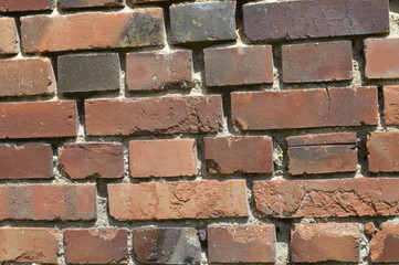 Old red brick wall with crushed mortar