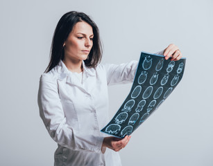 Doctor attentively examines the MRI scan of the patient.