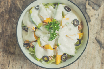 Organic fruit salad in the plate on a wooden table, close up. Bali island.