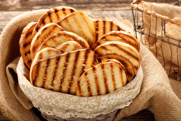 Fresh toast in basket on wooden background