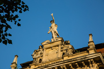 Statue of Mercury - a major Roman god standing on a building facade in city Lviv, Ukraine