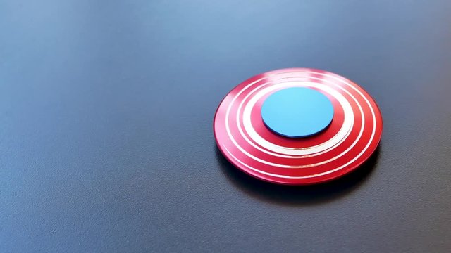 Popular colourful fidget spinner toy on a black background
