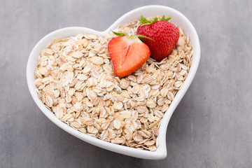 Dry rolled oatmeal in bowl.