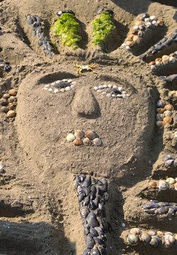 sarcophagus made by children on the beach of the sea with sand
