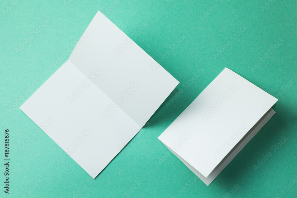 Poster white empty brochure on green background to replace your design. mockup.