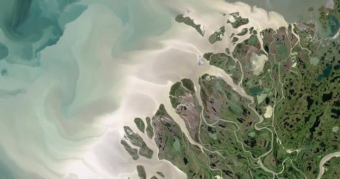 Very high-altitude overflight aerial of the Mackenzie River delta at the Beaufort Sea. Clip loops and is reversible. Elements of this image furnished by USGS/NASA Landsat