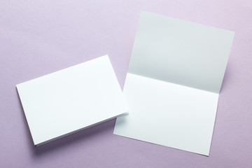 Paper blank business cards, brochures, flyers on a purple background. Mock-up.