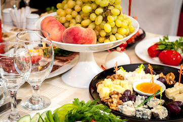 grilled meat and snacks on the table and
