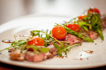 grilled meat and snacks on the table and
