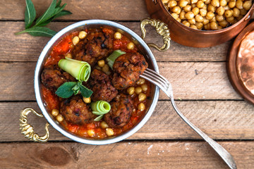 Arabian meatballs kofte with chickpeas, spicy tomato sauce and mint