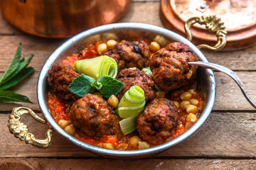 izmir kofte - Turkish traditional meatball with chickpeas. tomato sauce and mint