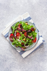 Vegetarian salad with lettuce, tomatoes, olives and bulgur