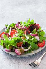 Vegetarian salad with lettuce, tomatoes, olives and bulgur