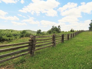 Wooden fence  along a pasture in the mountains