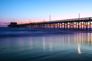 Fototapeta na wymiar View of pier on sea during sunset