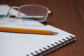 Eye glasses with pencil and binder notebook