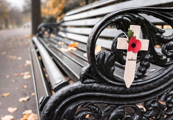 Poppy appeal remembrance cross on cast iron bench (Rememberance Day)