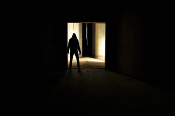 Silhouette of hooded person