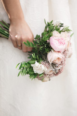 bride holds beautiful wedding bouquet