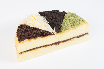 Healthy cheese cake whole topped with chocolate sprinkles, grated cheese, oreo chocolate cookies, and matcha green tea and chocolate filling.
