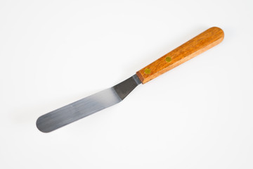 Metal spatula cake with wood handle isolated on white background