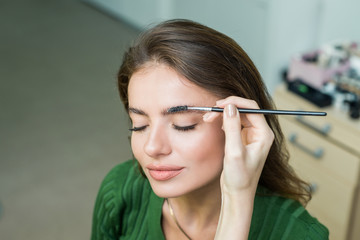 Woman paints the eyebrows