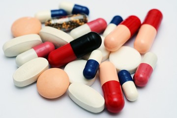 Pills close up over white