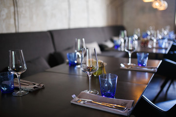 Glasses, flower fork, knife served for dinner in restaurant