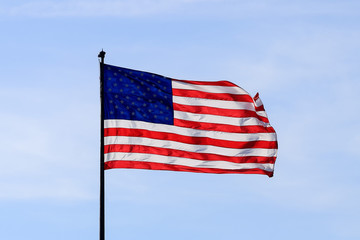 United States of America flag with cloudy blue sky