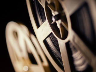 film projector on a black background with dramatic lighting and selective focus