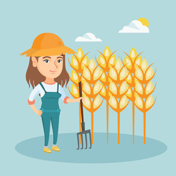 Young caucasian farmer in summer hat standing with a pitchfork on the background of a wheat field. Smiling farmer working with pitchfork in a wheat field. Vector cartoon illustration. Square layout.
