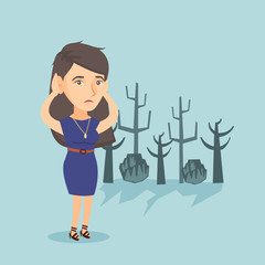 Young caucasian disappointed woman scratching head while standing in a dead forest caused by global warming or wildfire