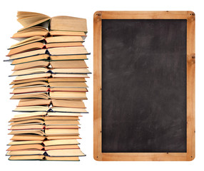 Stack of open  books with school blackboard