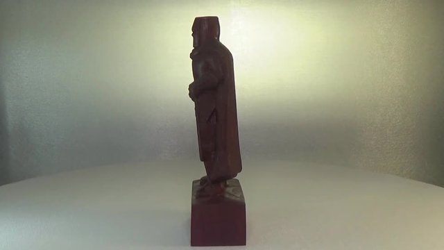 Woodcarving amarant. The figure of the Crusader is carved from wood. Sculpture of the Knight Templar.