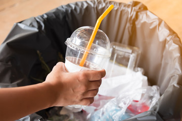 female hand putting trash