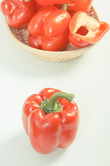 Vintage photo, Red ripe peppers with wicker basket on white background, healthy nutrition