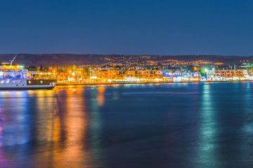 Night view of the embankment in the harbor of Paphos, Cyprus.