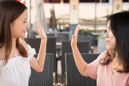 tow girls high five