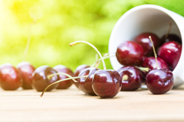 Cherries on wooden table in morning light