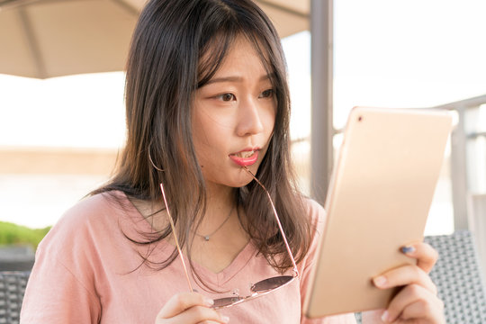 asian girl watching tablet