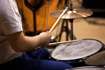 Fototapeta na wymiar Hands of a man playing a drum set