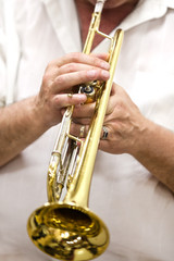 Fototapeta na wymiar Hands of the musician playing a trumpet closeup 
