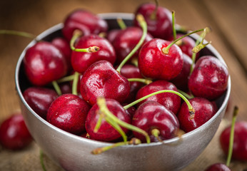 Fresh Cherries on vintage wooden background