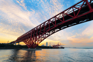 Red Bridge, Minato Bridge over Osaka sea port at sunset, Japan.