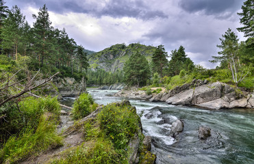 Picturesque summer mountain landscape with fast river among rocks