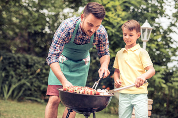 Father and son having a barbecue party