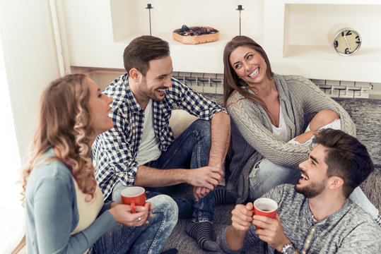 Group of friends talking and having fun while sitting on the couch